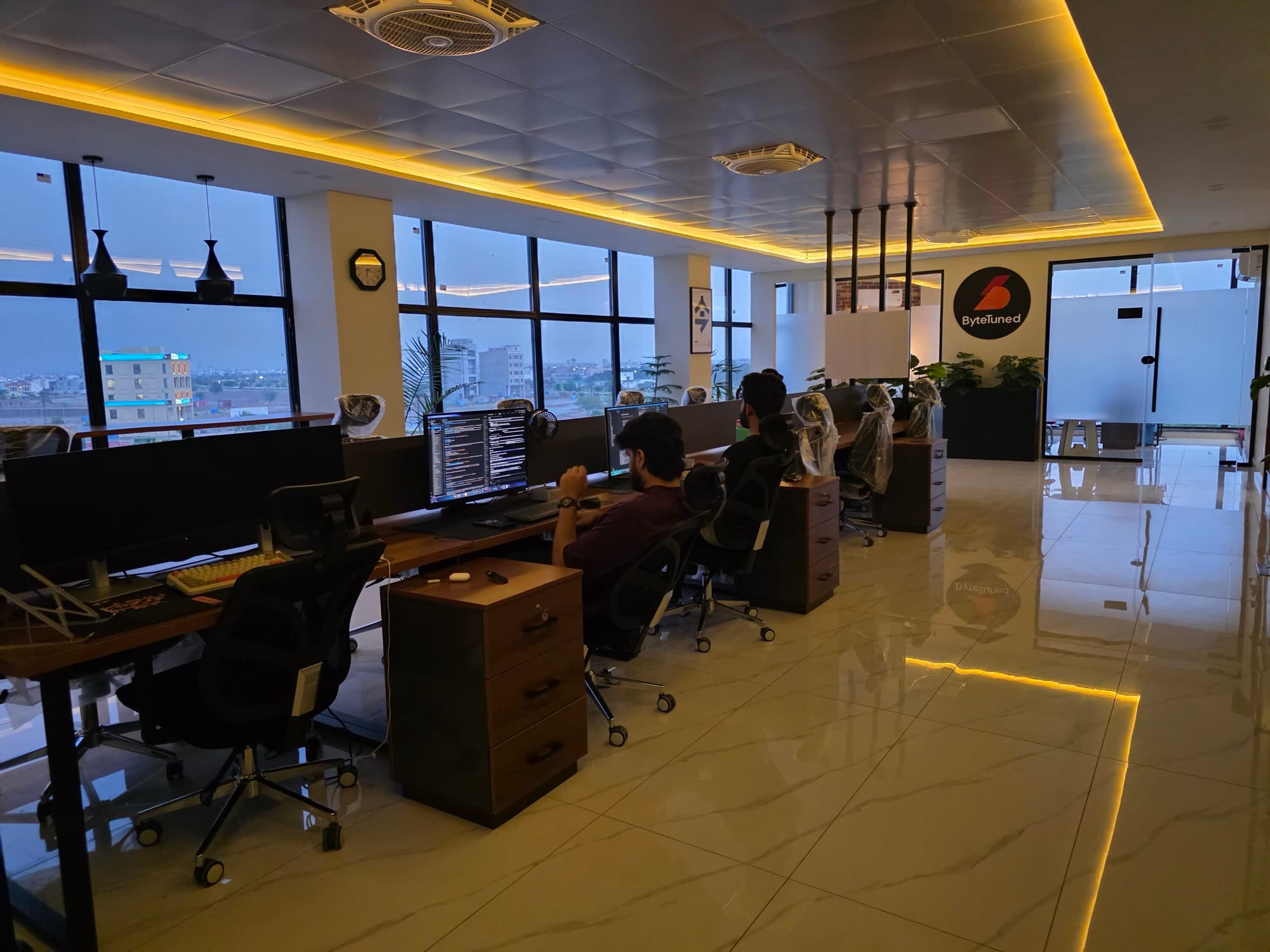 Wide view of the ByteTuned engineering floor with engineers working